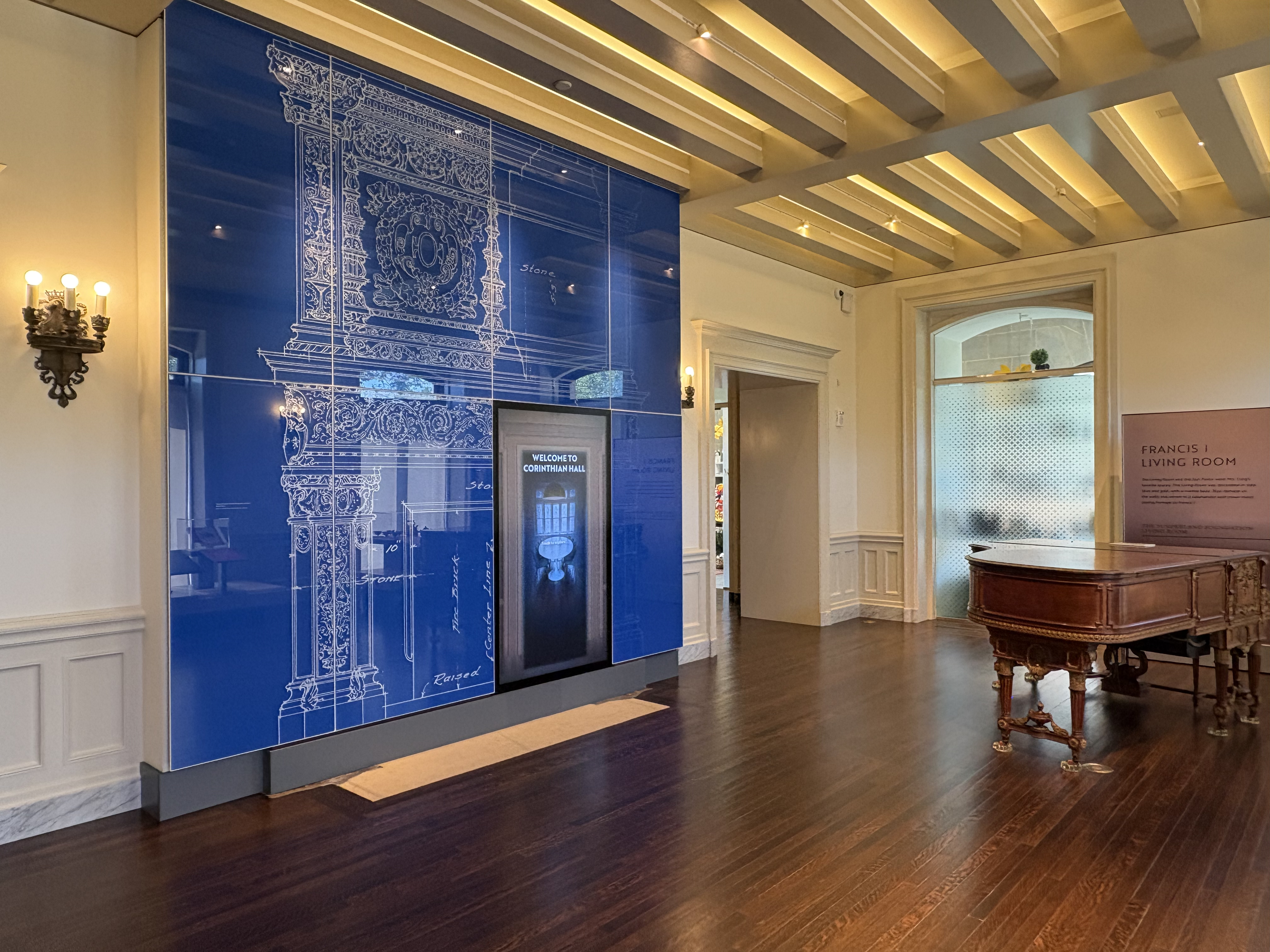 Welcome Corinthian Hall — touchscreen set into the fireplace blueprint wall